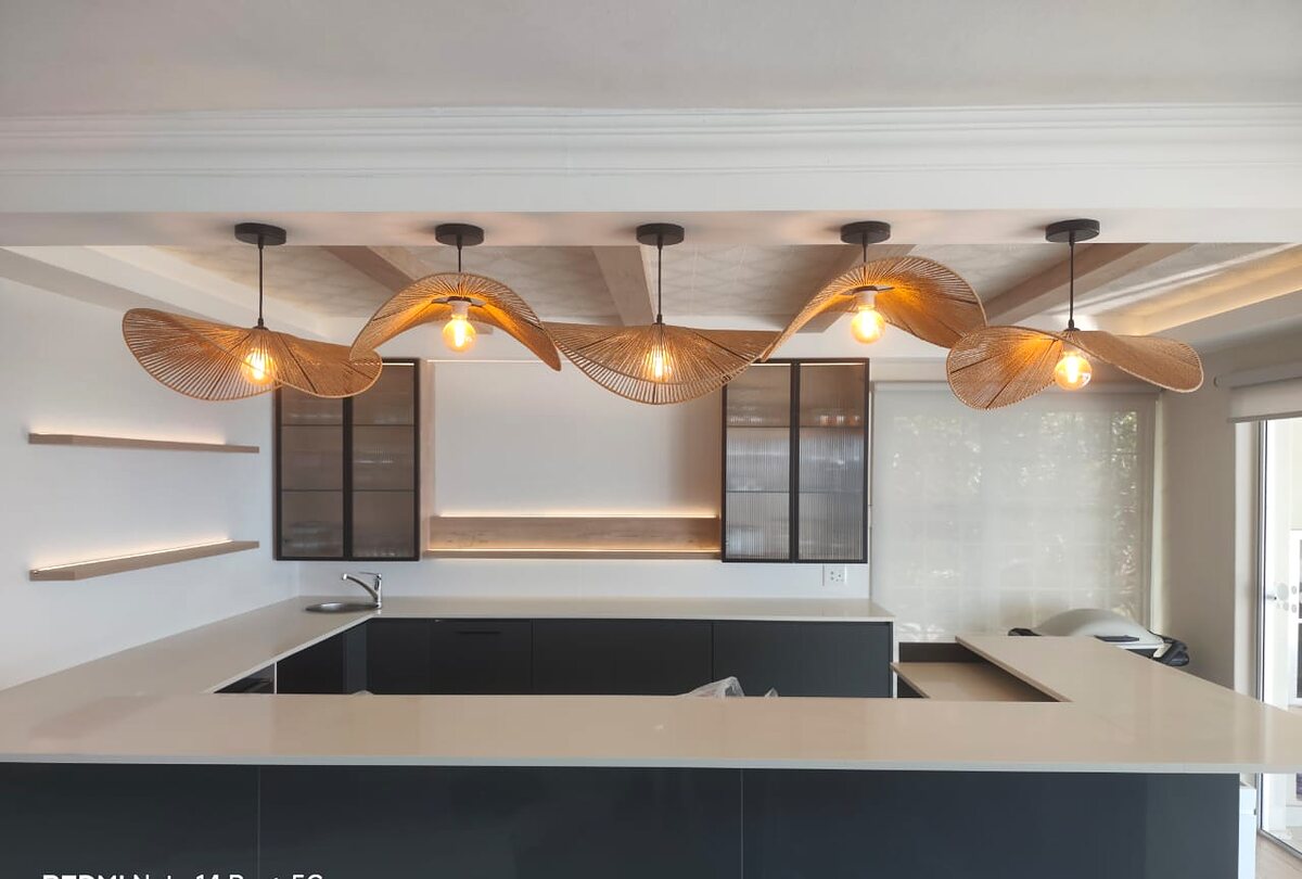 Designer kitchen with sculptural pendant lighting installed by Open Circuit