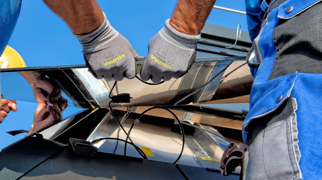 Open Circuit solar panel installers fitting a panel on site in Durban